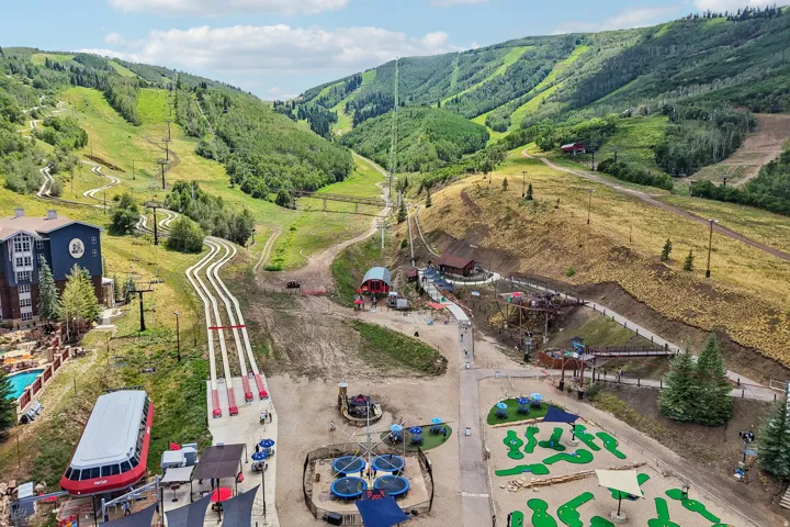 Mountain landscape featuring ski slopes and green hills