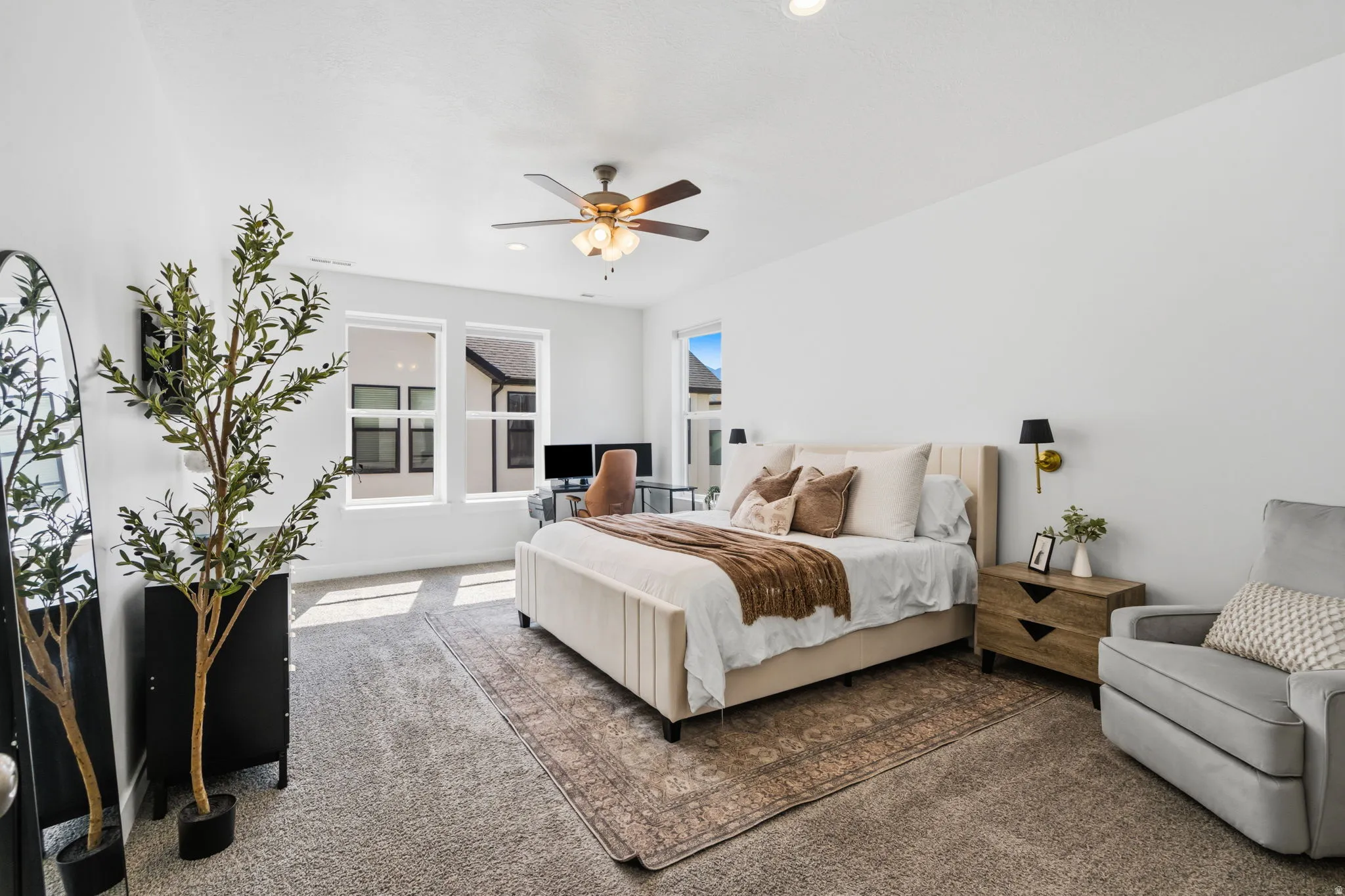 Spacious room with white walls and soft gray carpeting