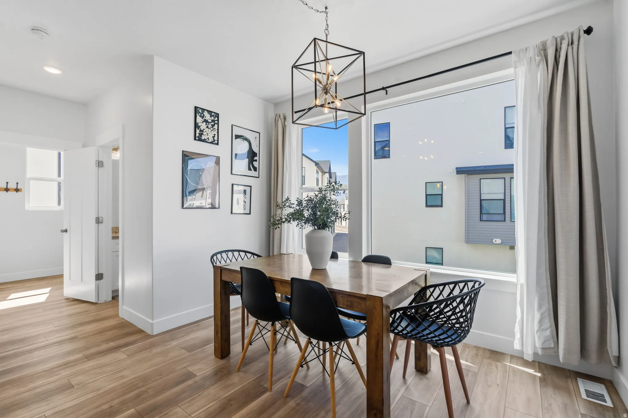 Dining area featuring wood-finish flooring and a large picture window