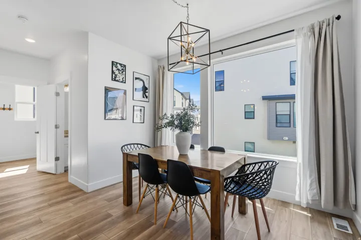 Dining area featuring wood-finish flooring and a large picture window