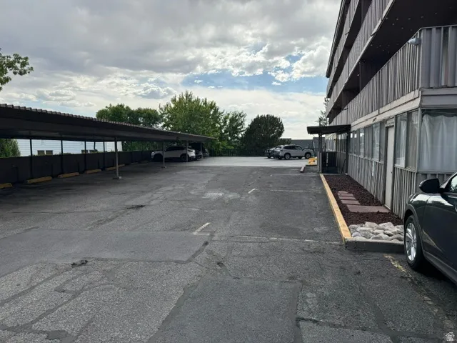 Paved parking area featuring a multi-car covered carport for those who don't have underground parking