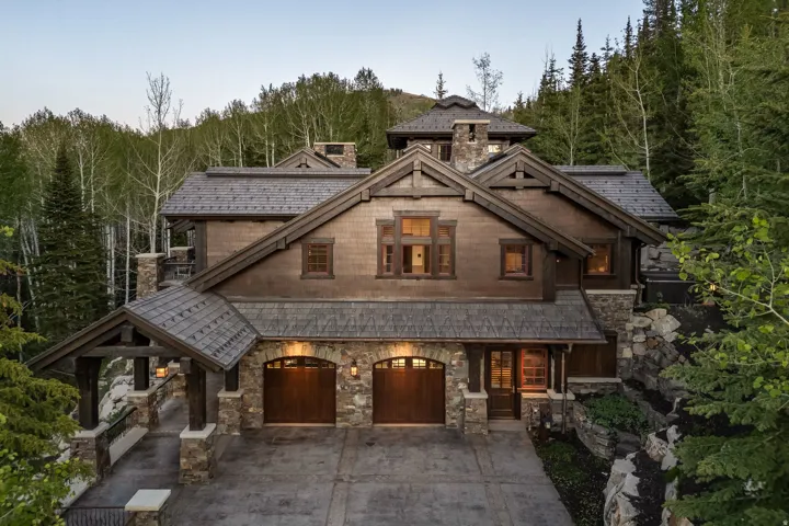Rustic-inspired architecture featuring a stone and wood-shingle exterior