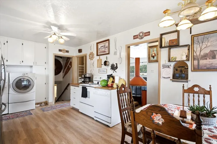 Bright kitchen featuring white cabinetry and wood-finish flooring