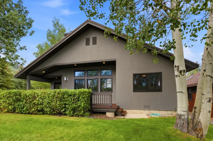 Gray stucco exterior with a dark trim roofline