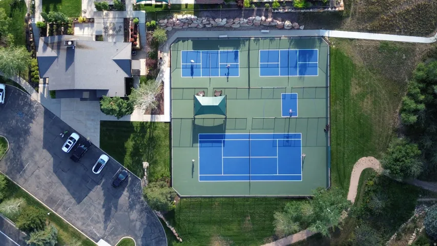 Expansive recreational courts featuring two tennis courts, two pickleball courts, and a half-court basketball court