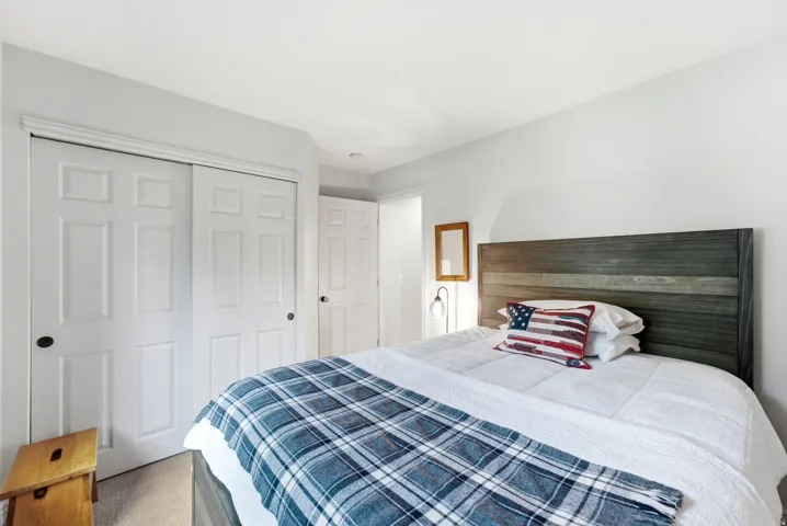 Bedroom with light gray walls and recessed ceiling lighting