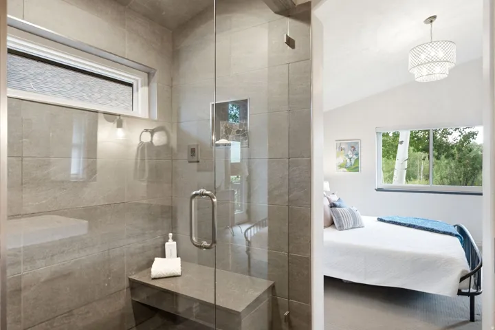 Walk-in shower with full-height tile surround and integrated bench