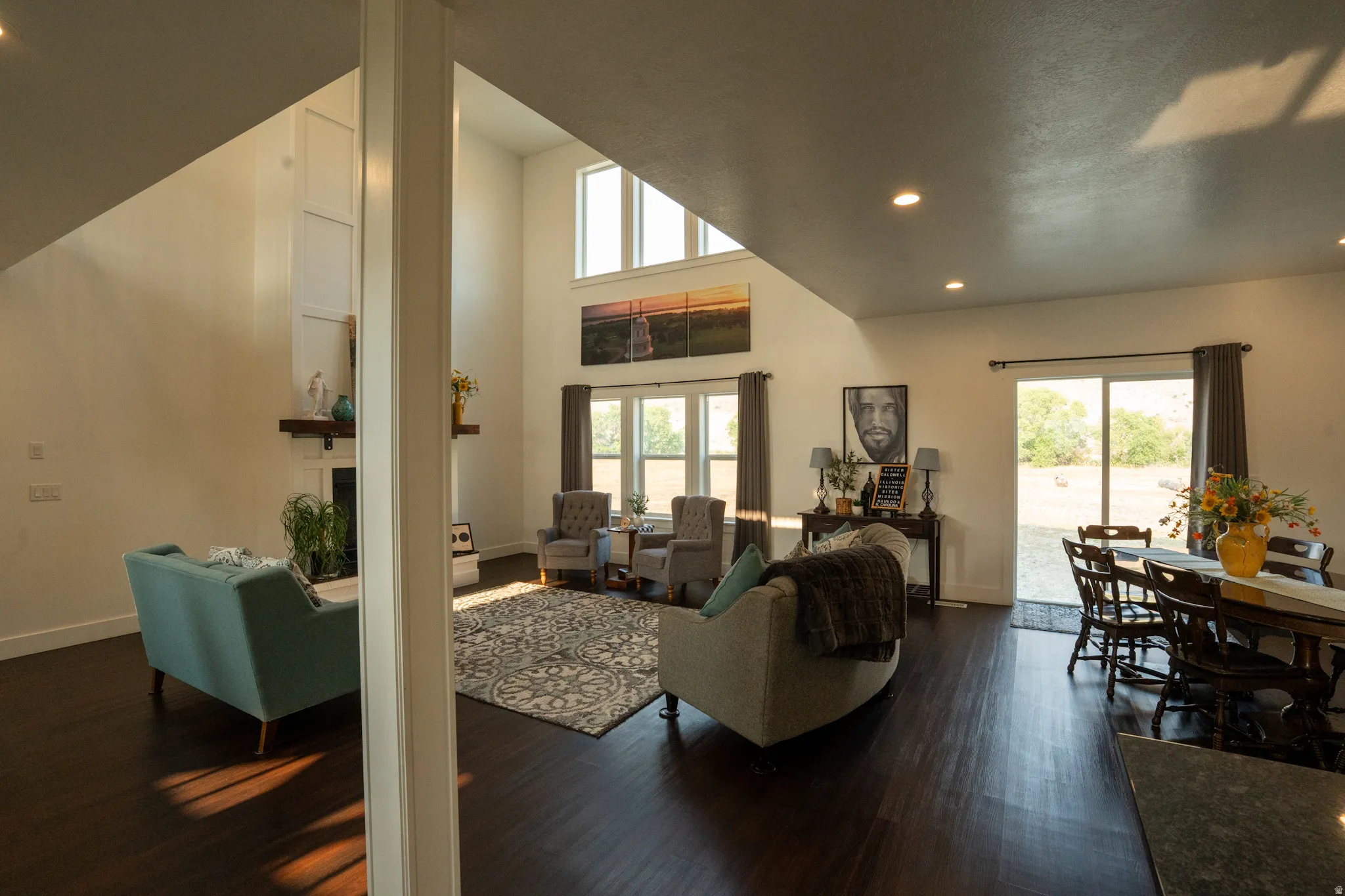 Open-concept living area featuring dark wood-finish flooring, recessed lighting, and a vaulted ceiling