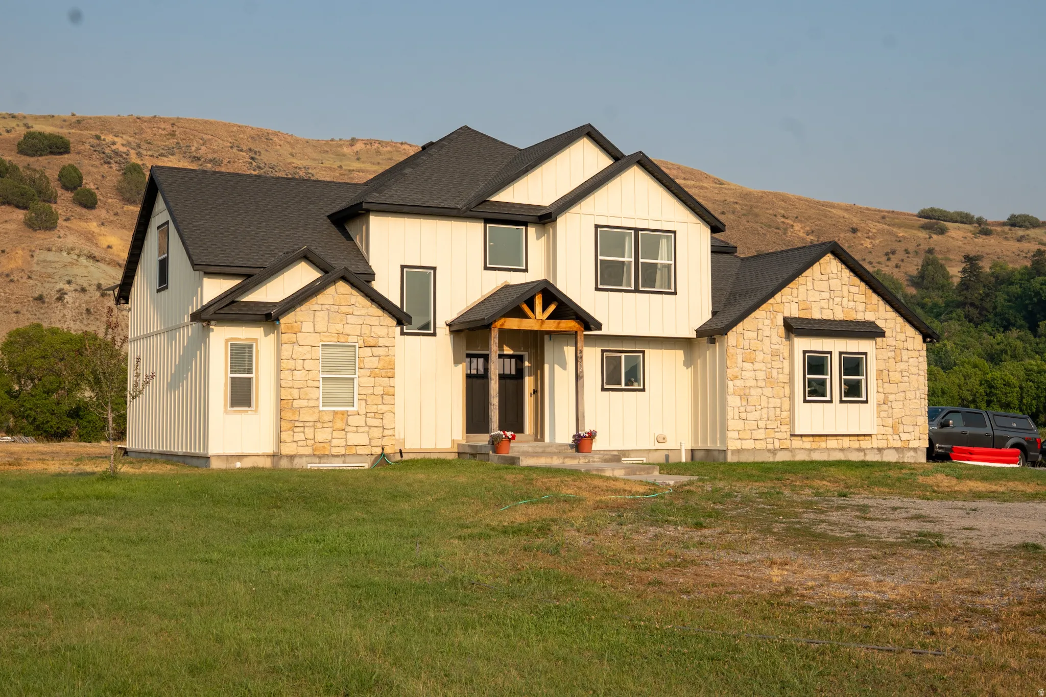 Modern farmhouse exterior featuring board and batten siding and stone accents
