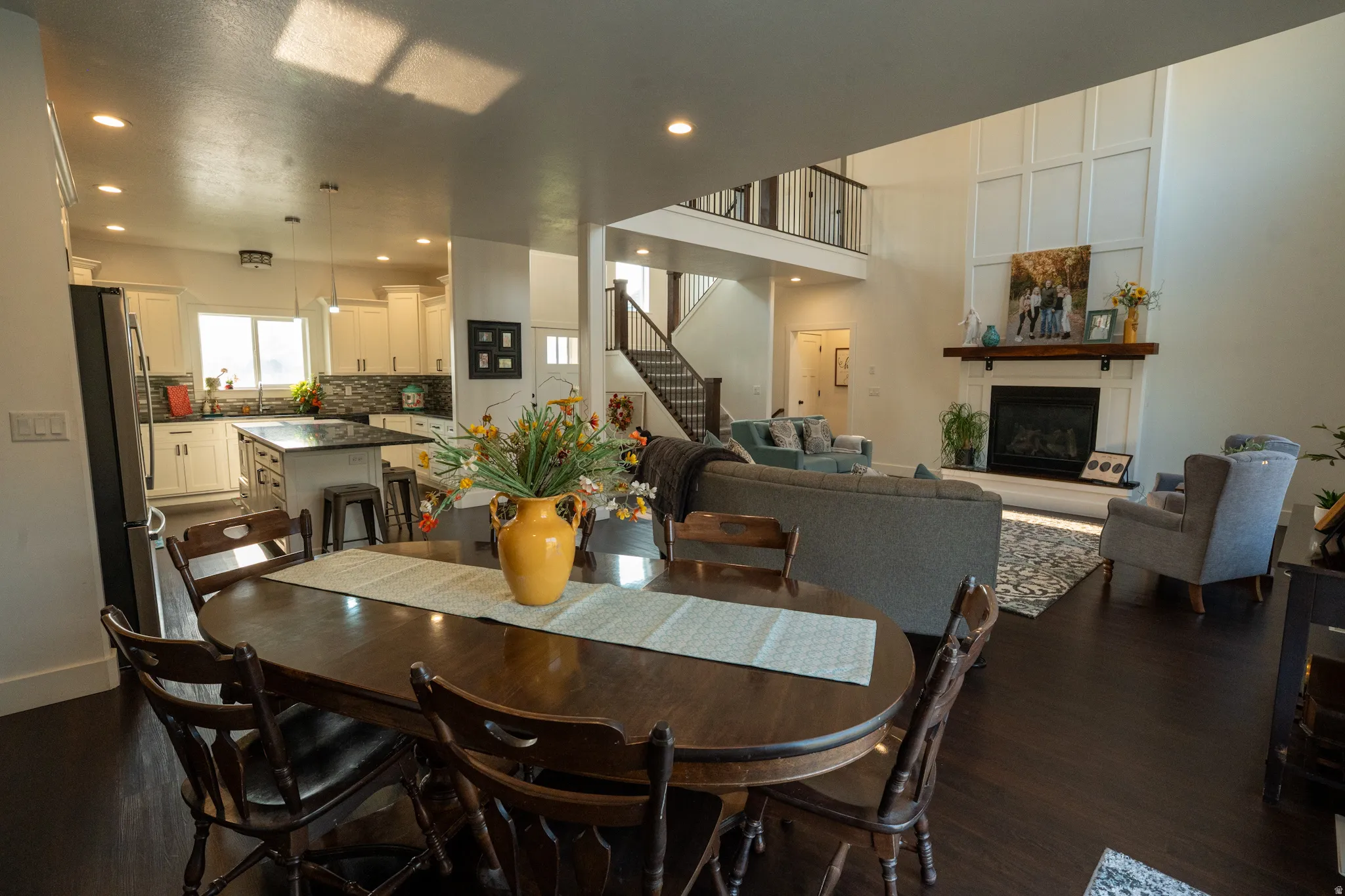 Open-concept living area featuring dark wood-finish flooring