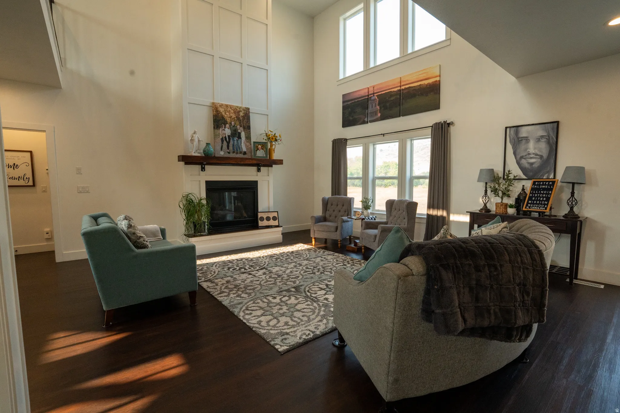 Soaring two-story great room with floor-to-ceiling windows flooding the space with natural light