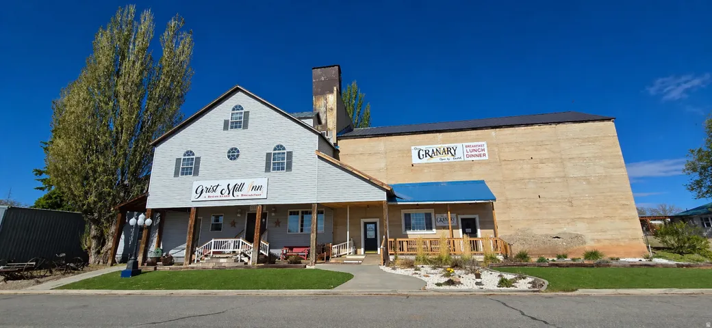 Multi-level commercial structure featuring a prominent gabled roof section with dormer windows