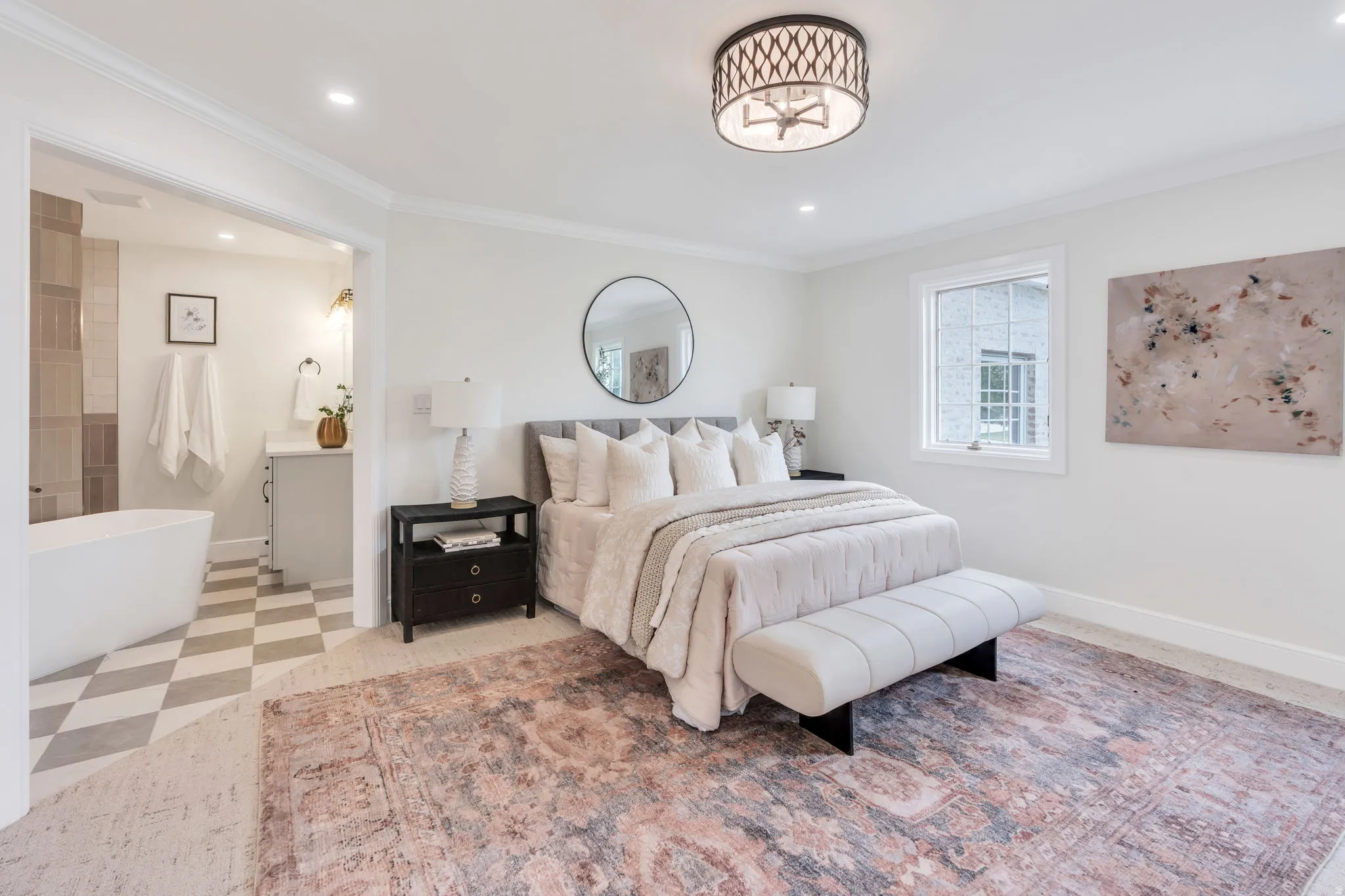 Spacious bedroom with an en-suite bathroom featuring a freestanding tub