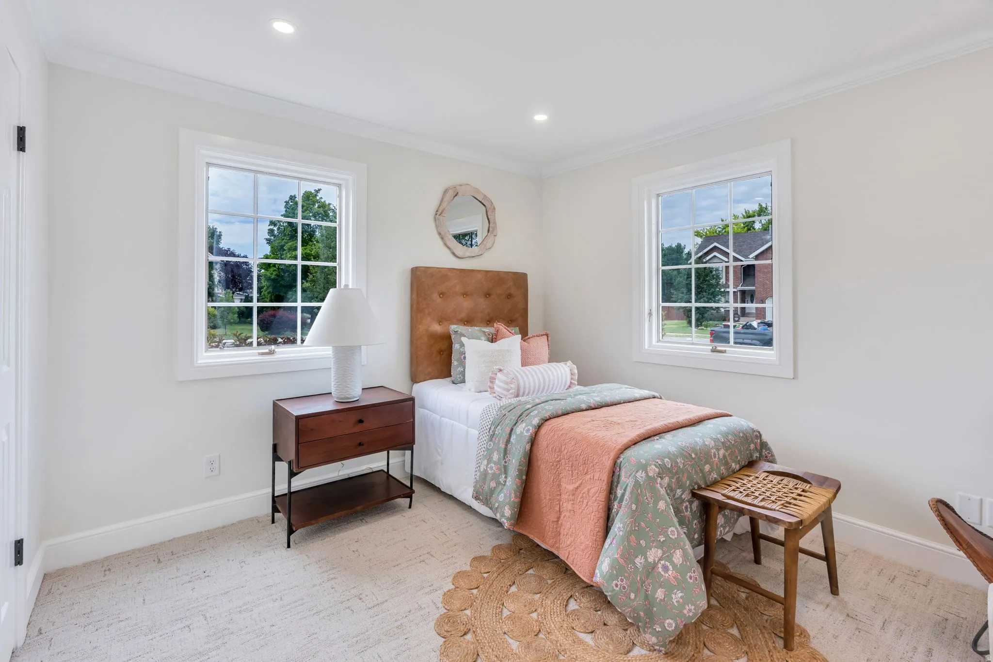 Bedroom featuring two multi-pane windows, recessed lighting, and crown molding