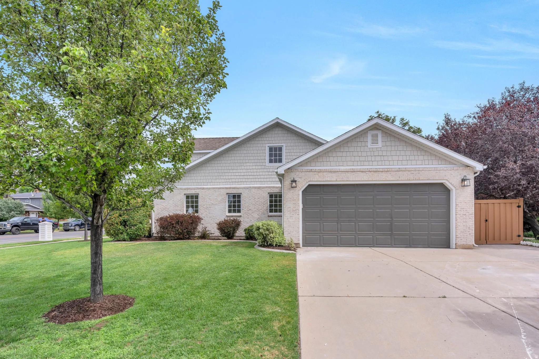 Stucco and shingle-sided residence with a two-car garage and concrete driveway