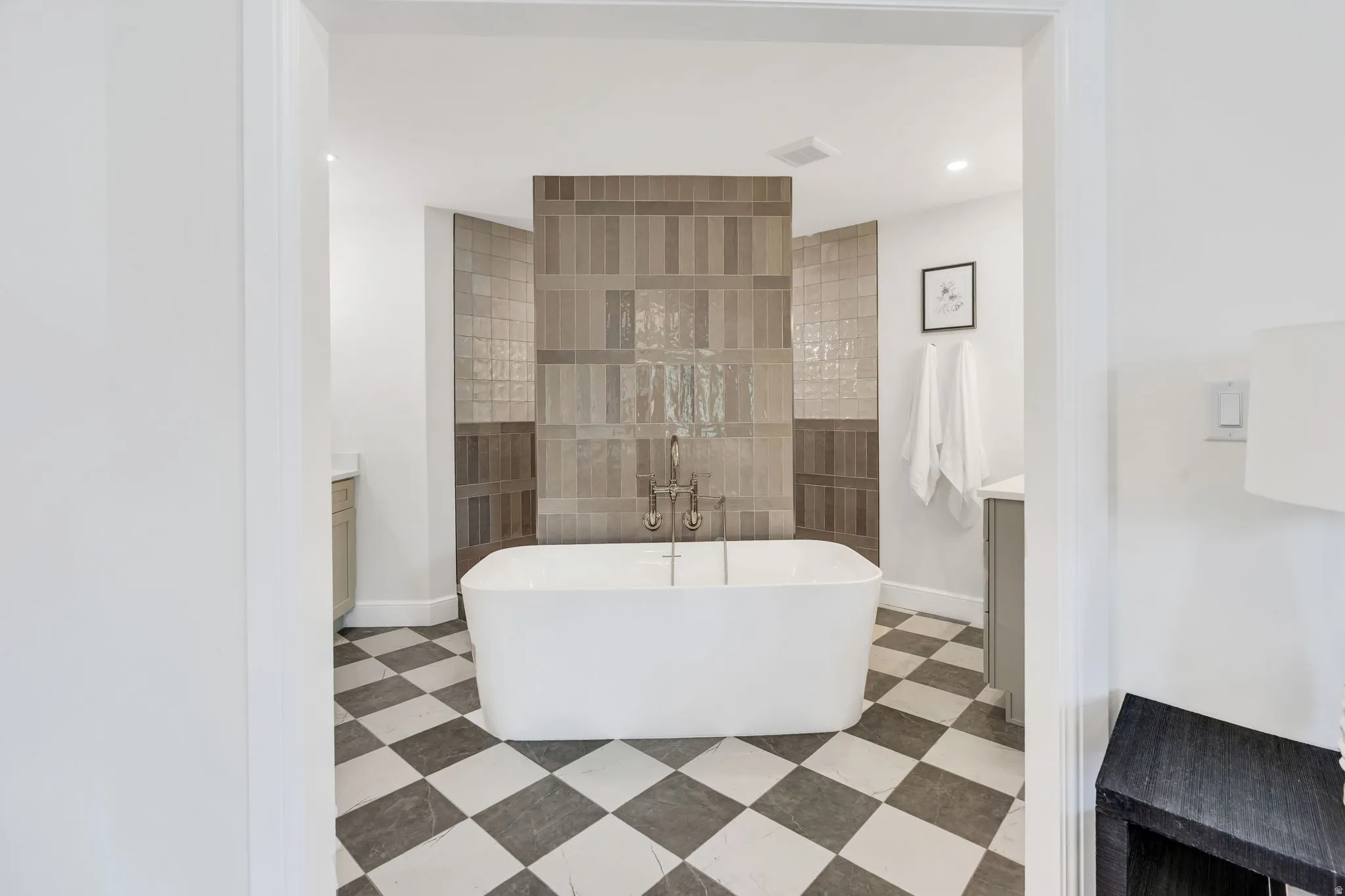 Freestanding soaking tub with floor-mounted faucet