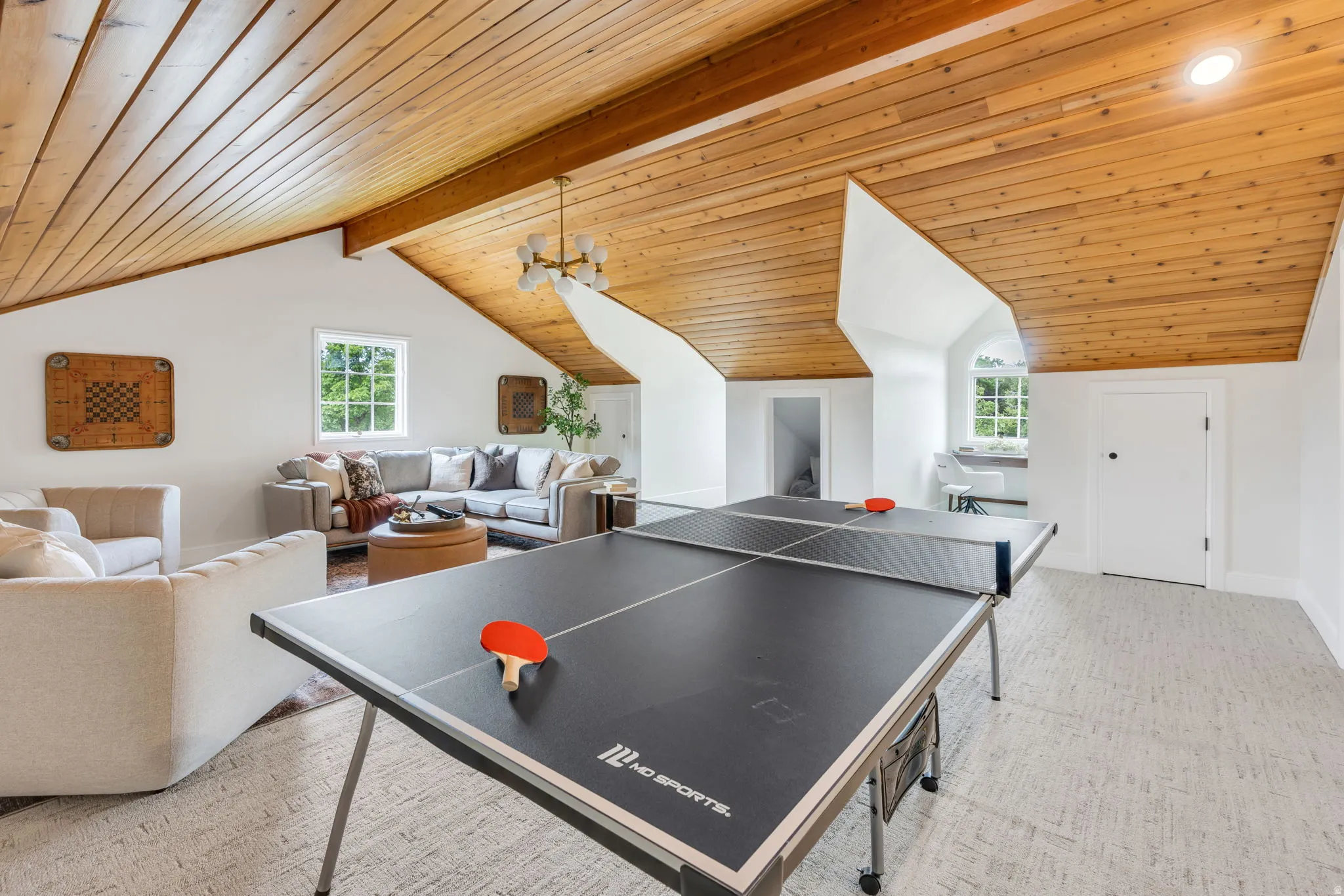 Spacious bonus room featuring a sloped wood-paneled ceiling, recessed lighting, and a neutral carpeted floor