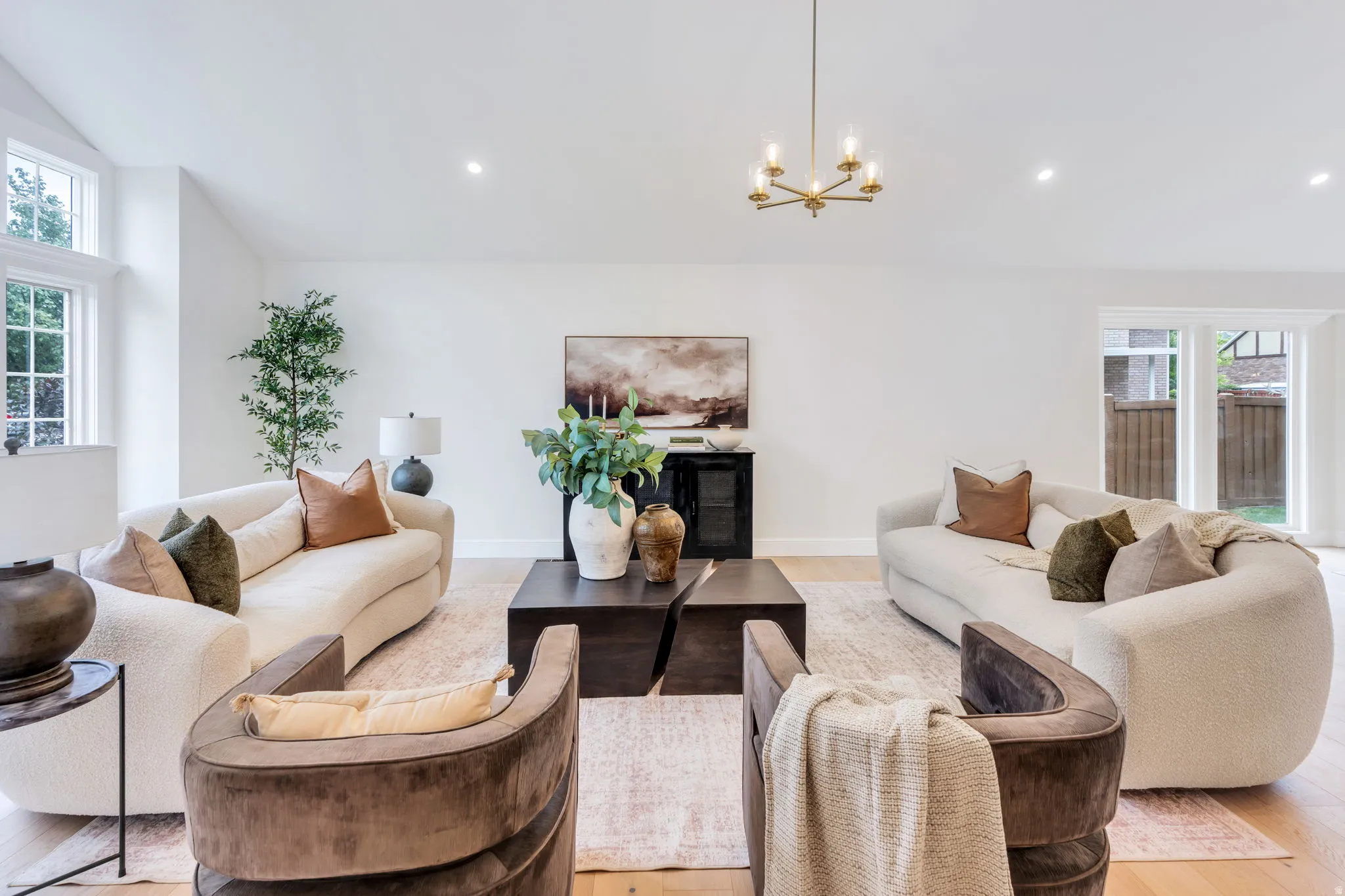 Bright living space featuring light wood-finish flooring and recessed lighting