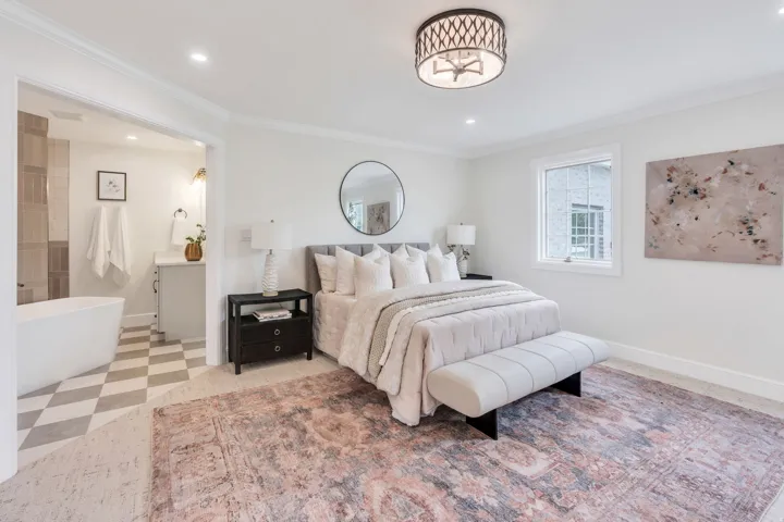 Spacious bedroom with an en-suite bathroom featuring a freestanding tub