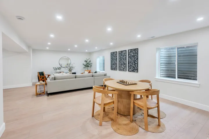 Spacious room featuring light wood-finish flooring, recessed lighting, and white baseboards