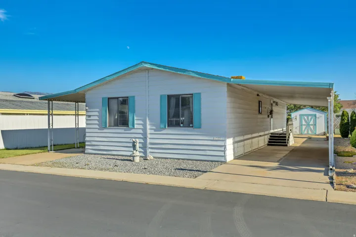 White siding exterior with turquoise trim accents