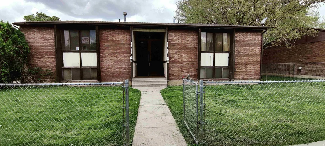 Brick facade property featuring a central entryway