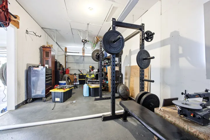 Garage space featuring a concrete floor and a metal overhead door