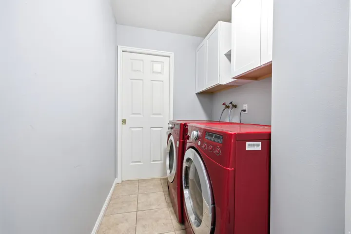 Dedicated utility space featuring tile flooring