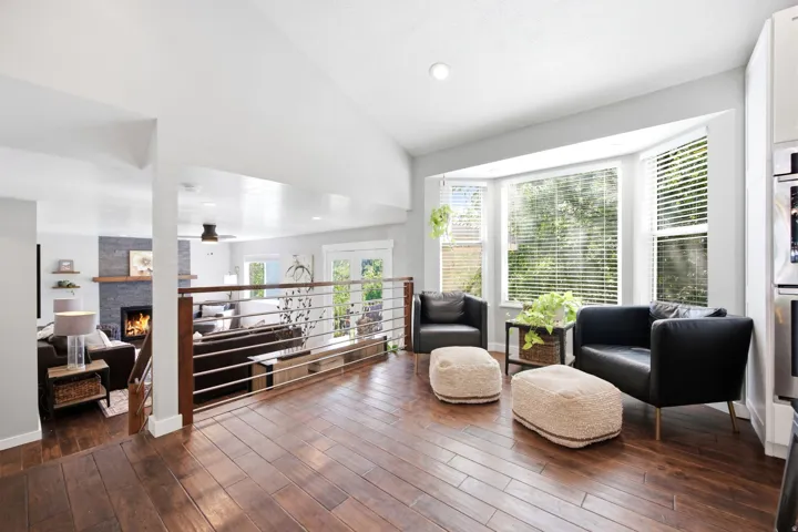 Upper-level living space featuring wood-finish flooring and a bay window