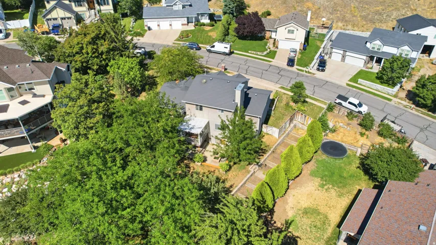Two-story residence with a gray exterior, dark roof, and a prominent chimney