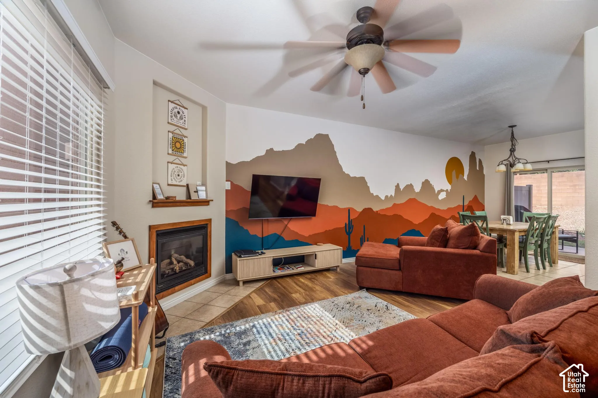 Living area featuring wood-finish flooring, a corner fireplace with a wood mantel, and an integrated wall niche