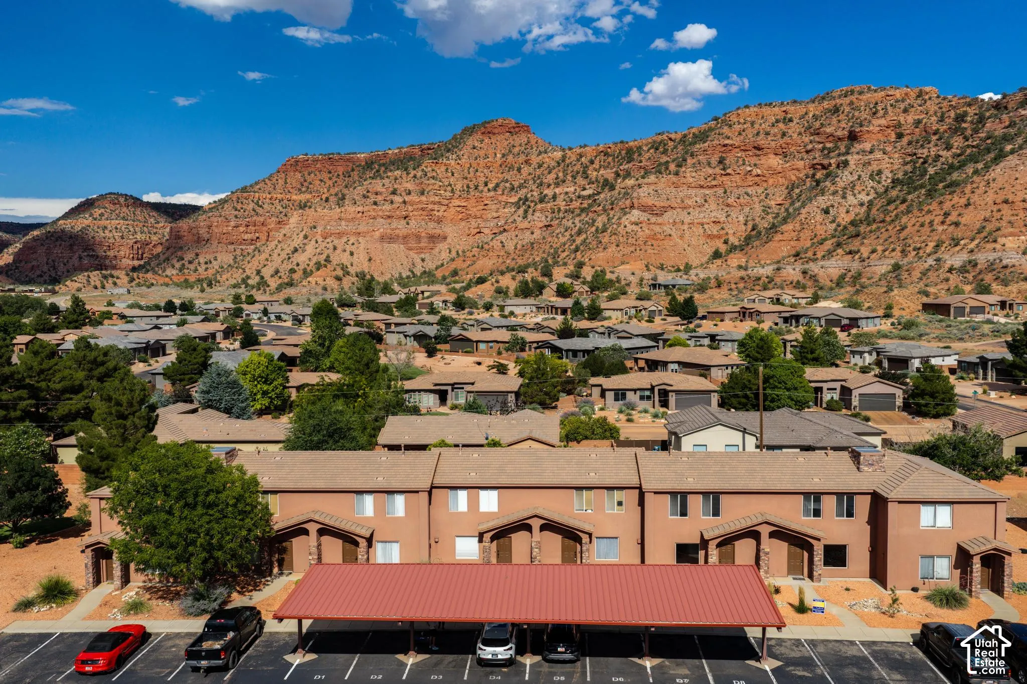 Multi-unit property with tan stucco exteriors and brown tile roofs