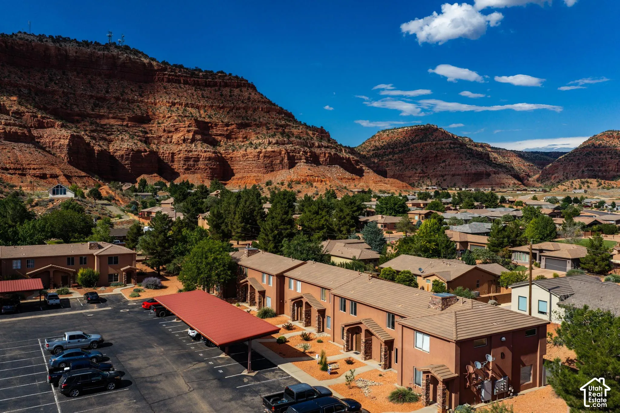 Terraced townhomes featuring stucco exteriors and tile roofs
