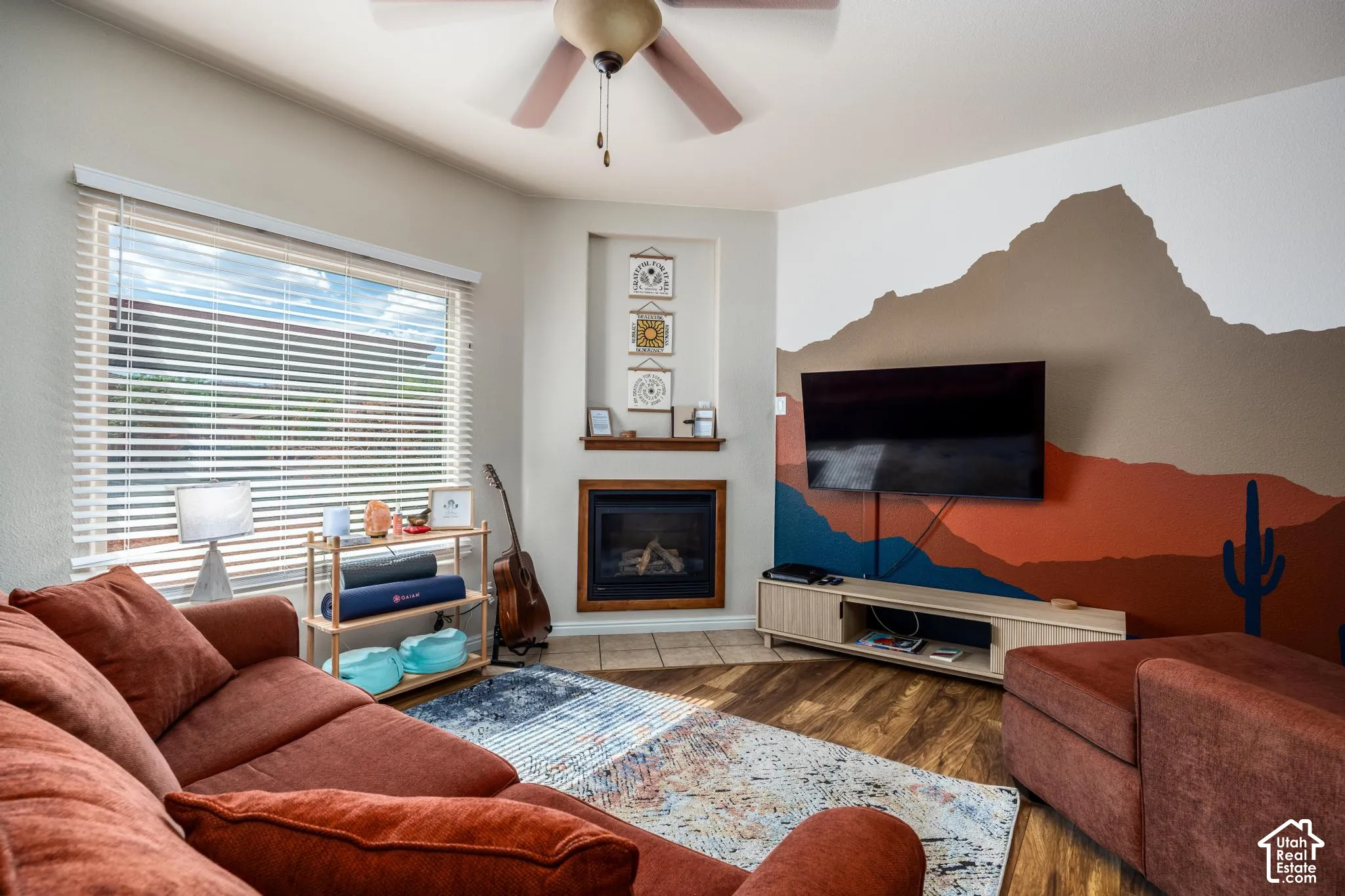 Living area featuring wood-finish flooring and a ceiling fan