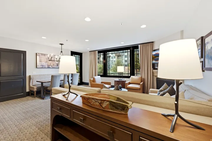 Living area featuring recessed lighting, a built-in banquette, dark-framed windows, and carpet flooring