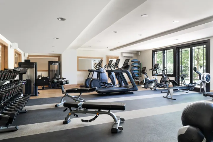 Dedicated fitness room featuring recessed lighting and wood-finish flooring