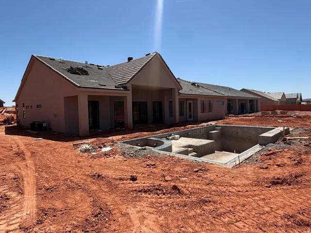 Rear exterior with stucco finish, covered patio, and tile roof