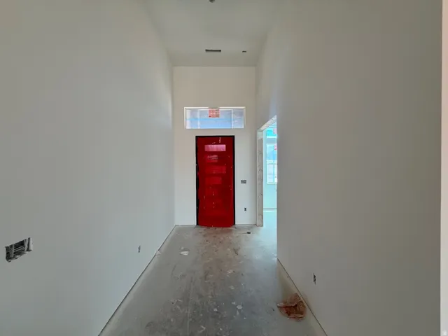 Transom window above a vibrant red entry door