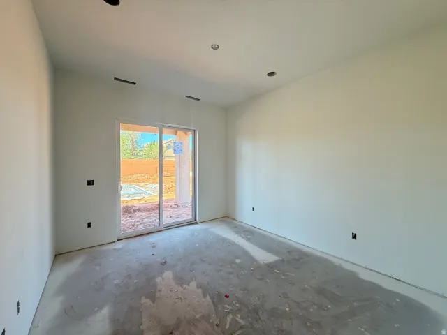 Sliding glass door, recessed ceiling lighting, smooth wall finishes, unfinished concrete flooring, outdoor light fixture