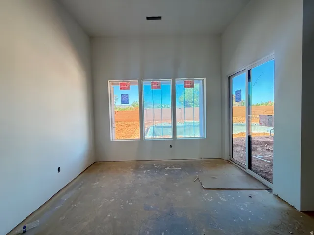 Three large windows and a sliding glass door provide ample natural light