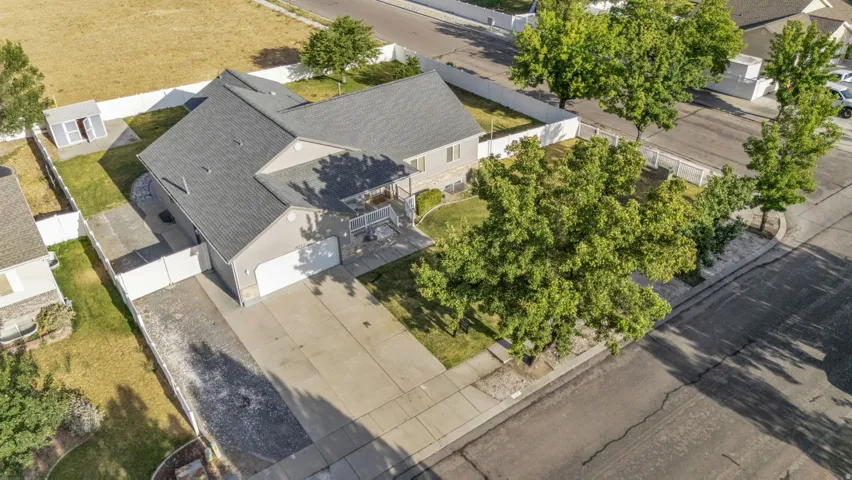 Ranch-style residence featuring a gray exterior, attached two-car garage, and a covered front porch