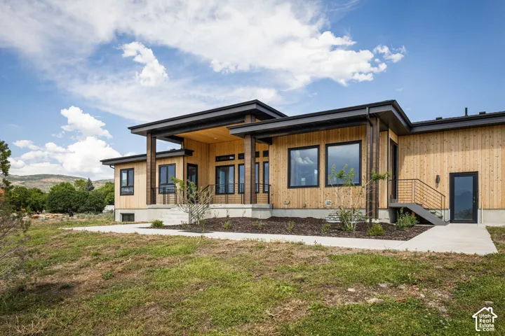 Contemporary home exterior featuring natural wood siding and a flat roofline