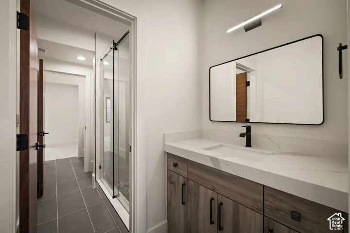 Bathroom featuring a floating wood-finish vanity with an integrated sink and white countertop