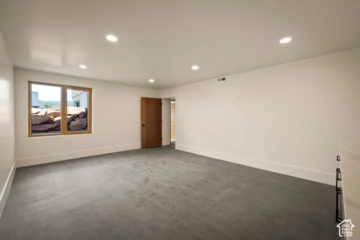 Spacious room with light gray flooring and white walls