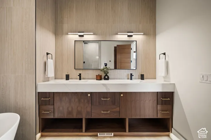 Dual sink vanity with dark wood cabinetry and a light-toned countertop