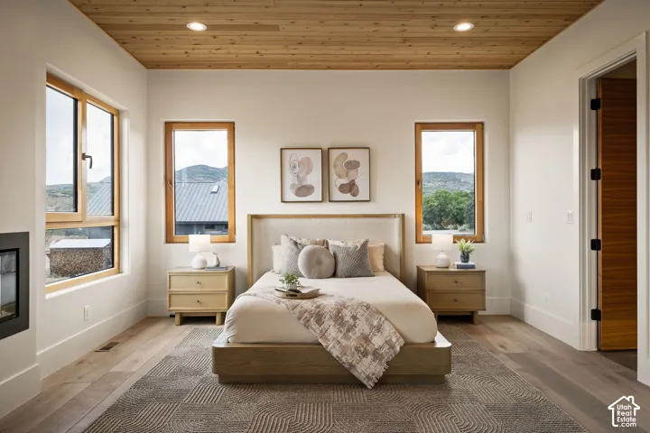 Recessed lighting illuminates a wood-paneled ceiling