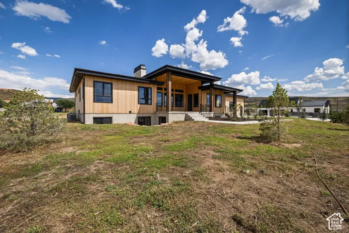 Contemporary exterior with natural wood-tone siding and dark-trimmed windows