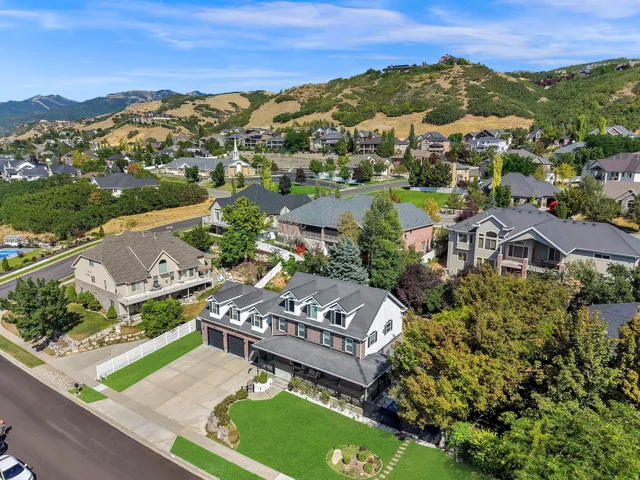 Traditional-style residence featuring a dark gray exterior, white trim, and a prominent front-facing two-car garage