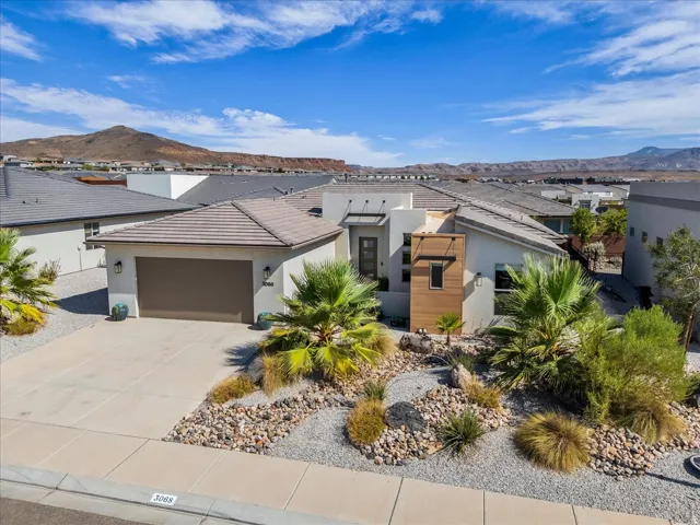 Contemporary desert dwelling featuring a stucco exterior with wood-look accents
