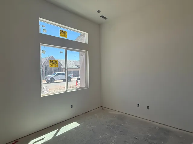 Contemporary interior with a large window, transom window, and smooth wall finishes